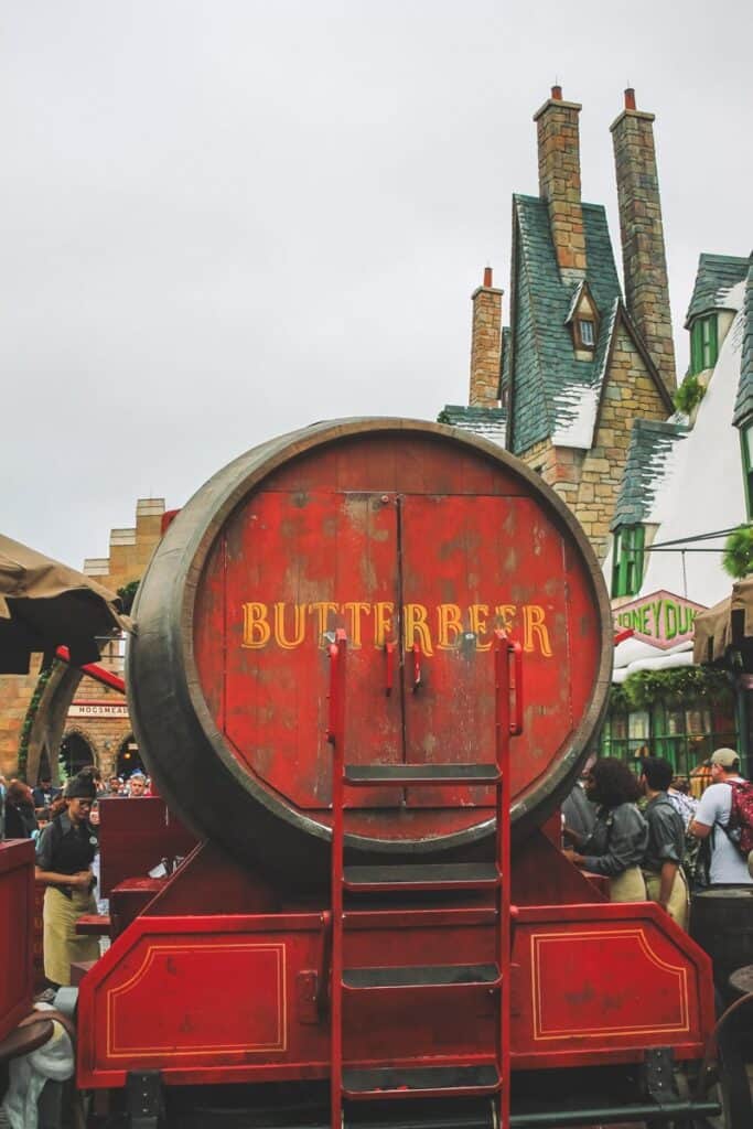 Large red wooden barrel stand. This is the main place to get Butterbeer inside Harry Potter World