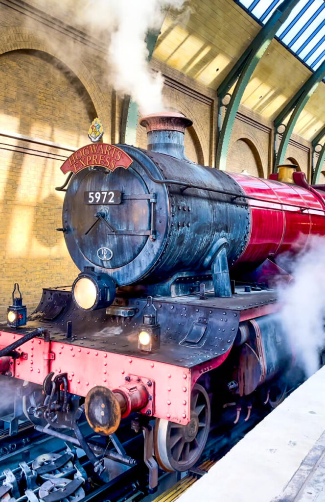 Hogwarts Express train billowing steam, one of my favorite things to do at Harry Potter World in Orlando Florida