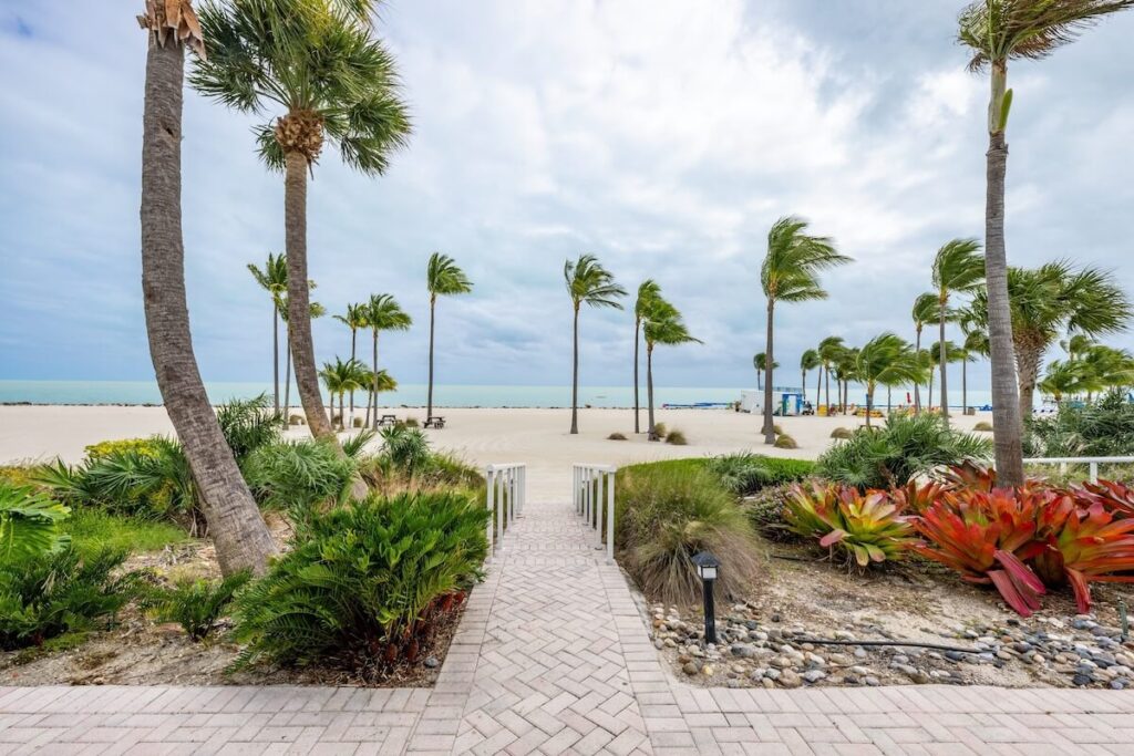 greenery and paved walkway leading to the beach at the Islander Resort in Islamorada, Florida, one of the top pet-friendly resorts in the Keys