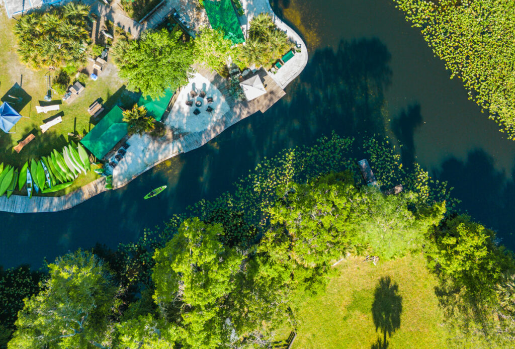 Top-down aerial view of the Wekiva Island riverfront with rental kayaks and canoes lined up beside the cabanas