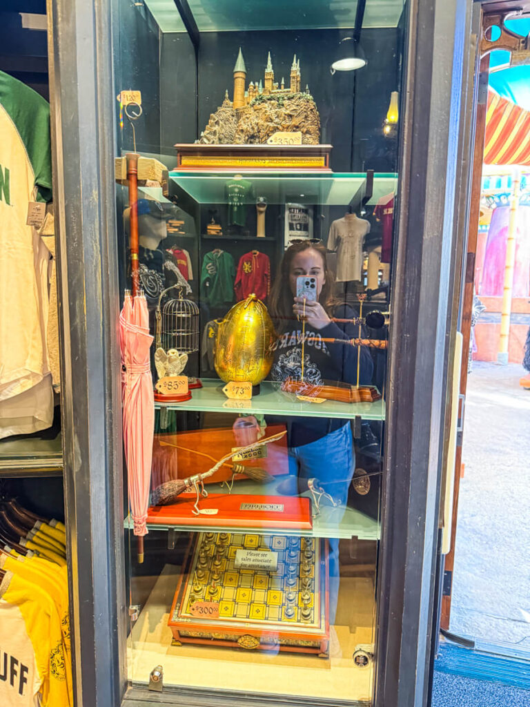 display of movie props from Harry Potter in a green case inside the souvenir shop of Islands of Adventure